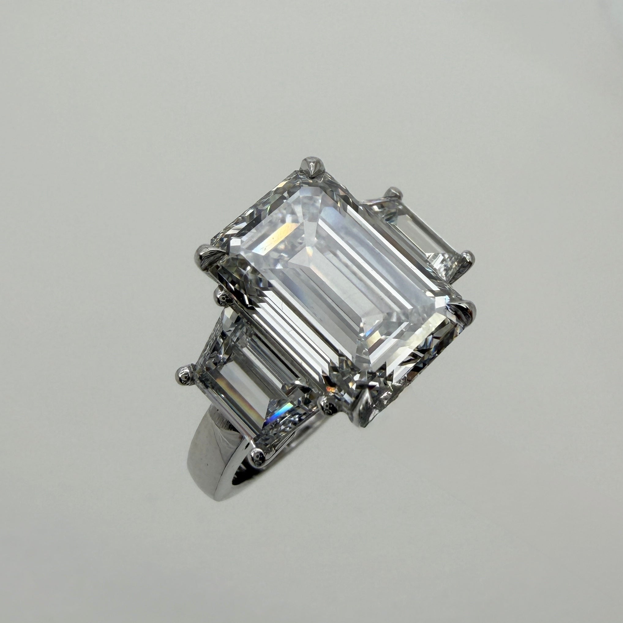 Diamond ring with emerald-cut center with step-cut side stones-Bijoux Village Fine Jewellers