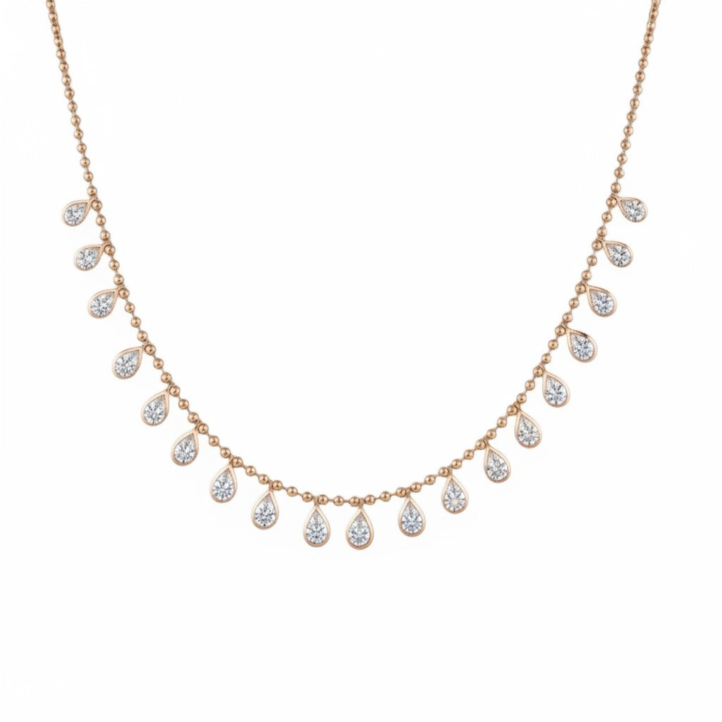 Bijoux Village Fine Jewellers 18K yellow gold necklace with bezel-set pear-shaped diamonds in a delicate fringe design.
