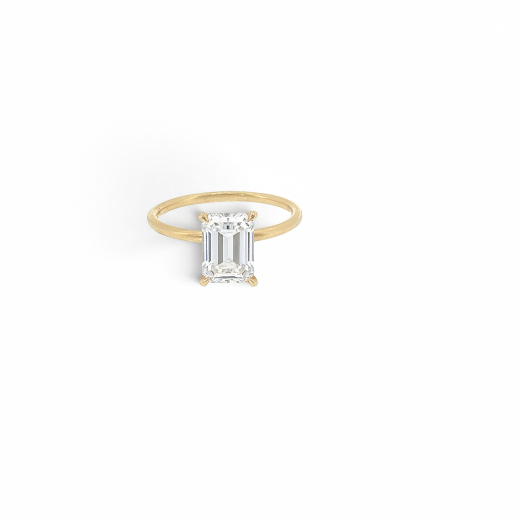 Bijoux Village Fine Jewellers 18K yellow gold ring with a 1.51 CT emerald-cut lab-grown diamond and hidden halo.