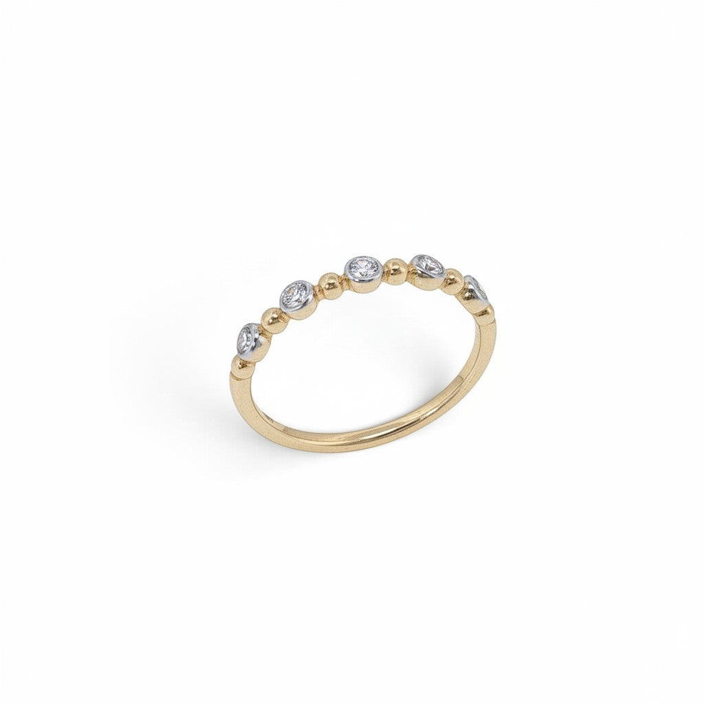 Bijoux Village Fine Jewellers 10K yellow gold stacking ring with bezel-set lab-grown diamonds and polished gold beads.