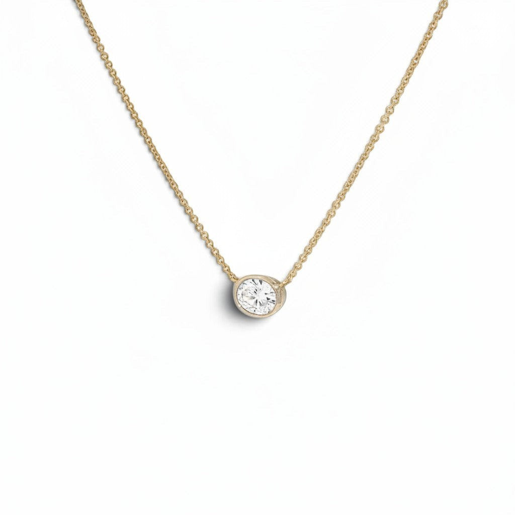 Bijoux Village Fine Jewellers 14K yellow gold necklace with a 0.48 CT oval natural diamond in a horizontal bezel setting