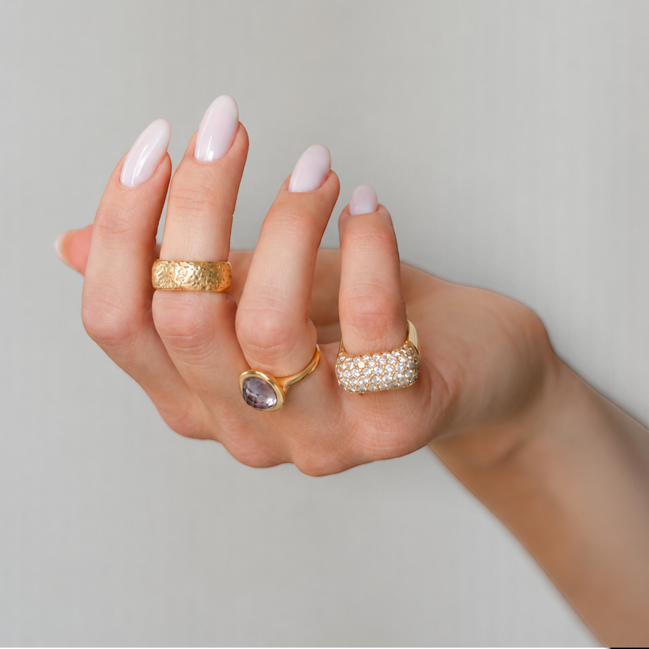 Bijoux Village Fine Jewellers vintage 18K yellow gold wide band with a textured finish worn on a woman's finger.