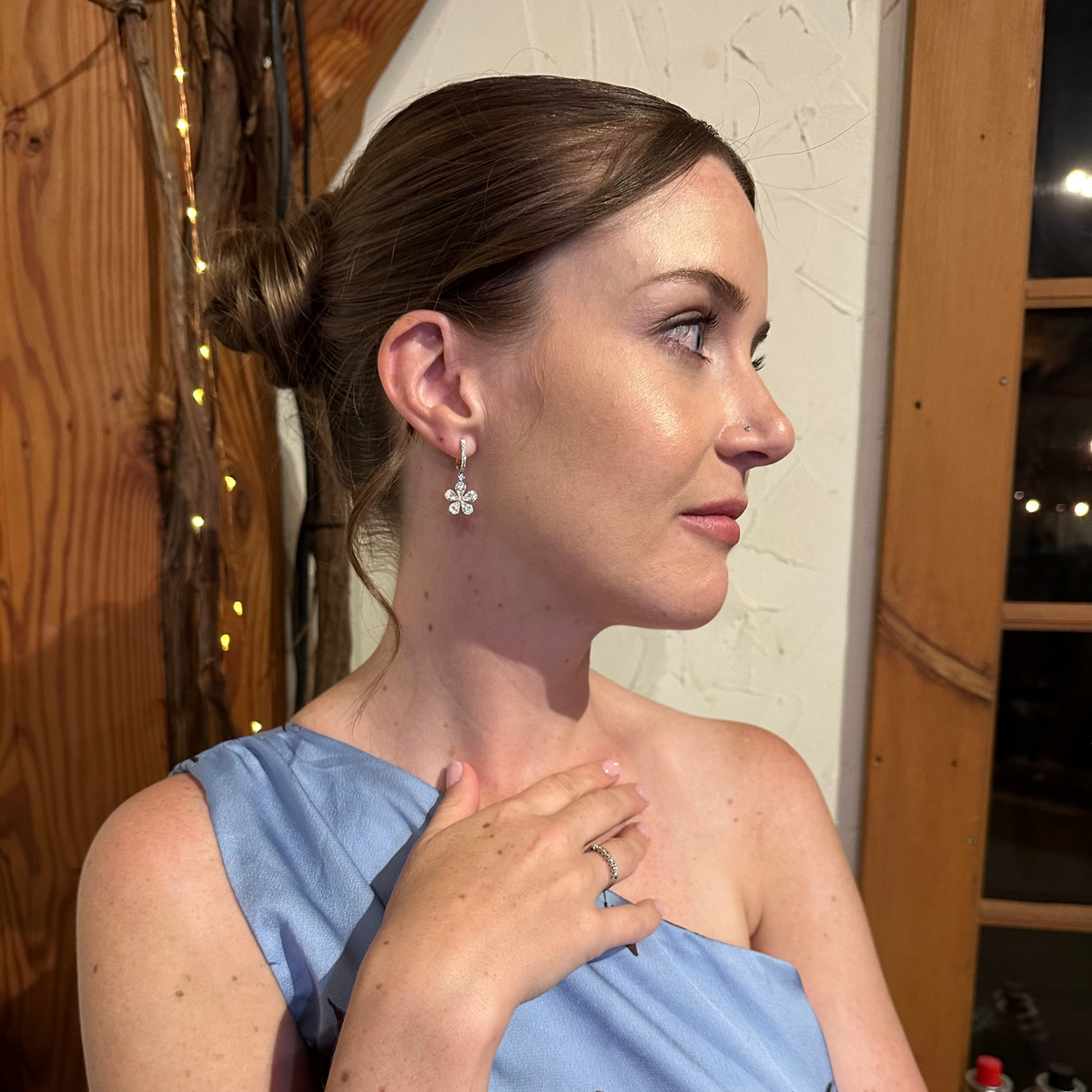 Bijoux Village Fine Jewellers 18K white gold floral drop earrings with pear and round diamonds on a woman
