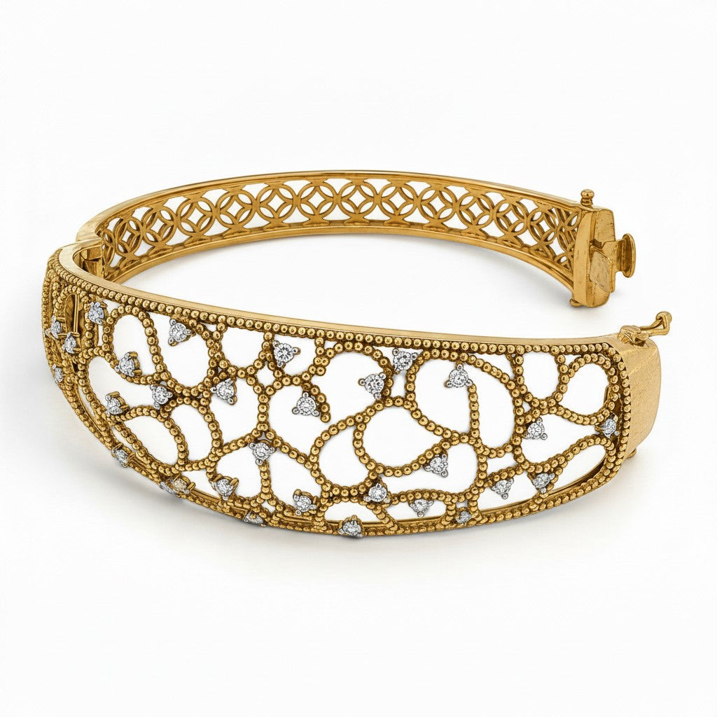 Bijoux Village Fine Jewellers 14K yellow gold Italian hinged bangle featuring intricate openwork and natural diamonds.