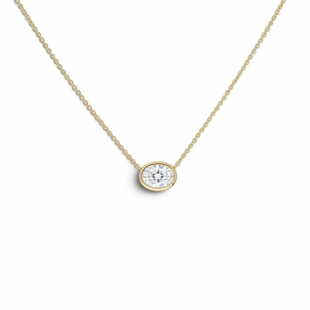 Bijoux Village Fine Jewellers 14K yellow gold necklace with a 0.48 CT oval natural diamond in a horizontal bezel set.