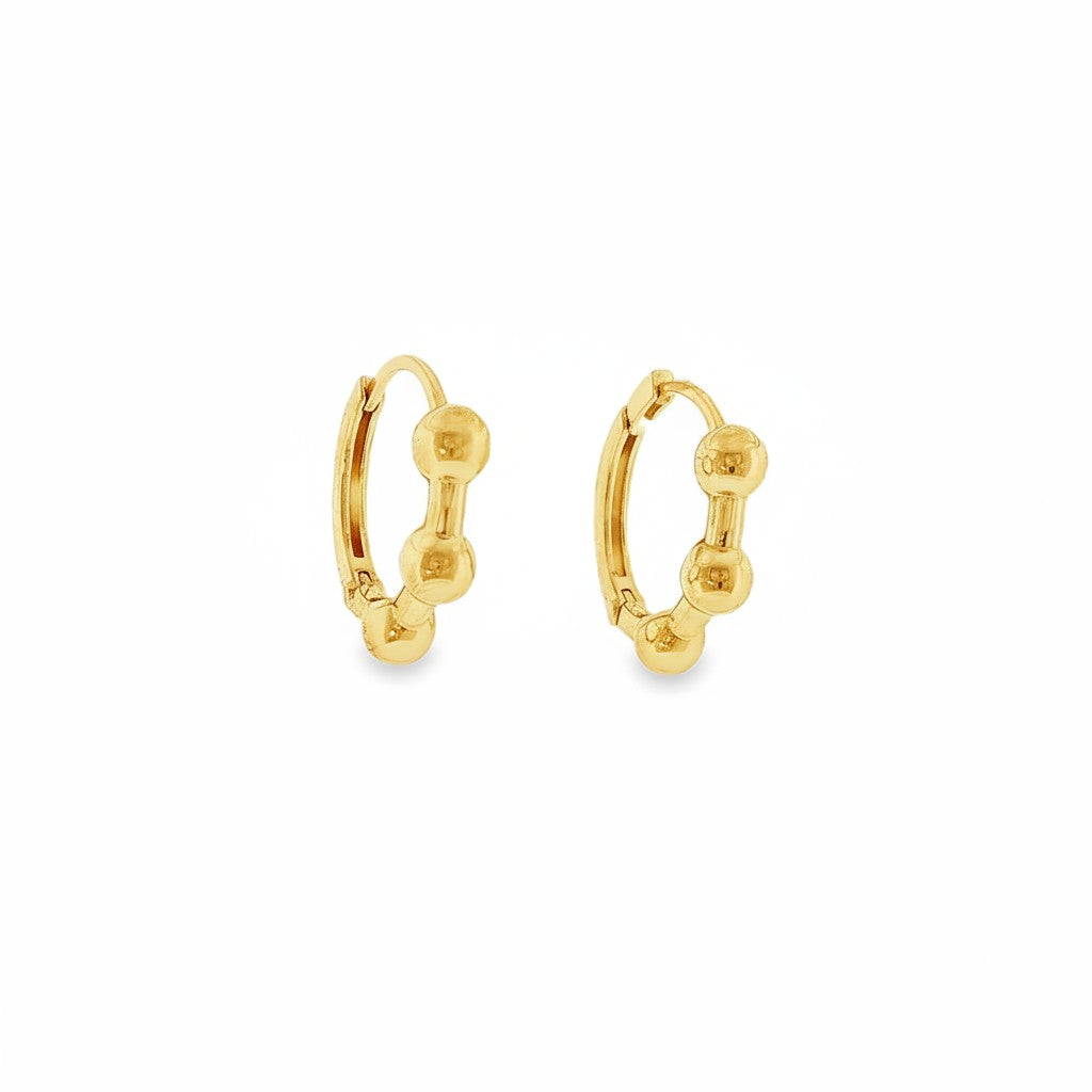 Bijoux Village Fine Jewellers 14K yellow gold huggie hoop earrings with a polished beaded design and hinged closure.